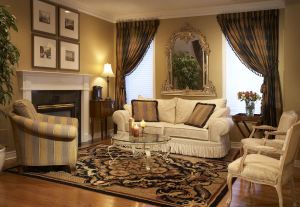 Beautiful custom drapery panels add drama to this living room, and bring attention to the ornate mirror.